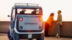 tazzari ev zeromax sfeerbeeld boven op een parkeerplaats met twee personen op de foto puramobi