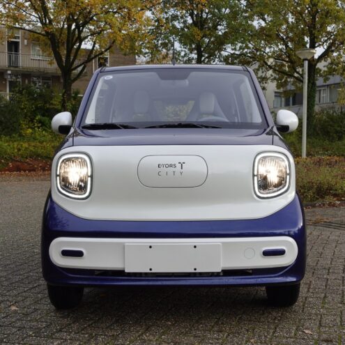 etors city blauwe brommobiel voorkant van het voertuig buiten bij een parkeerplaats puramobi